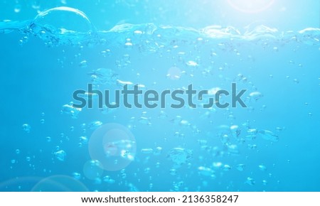 Water waves splash with air bubbles. Abstract blue water waves on a white background. for a product, advertising,text space.