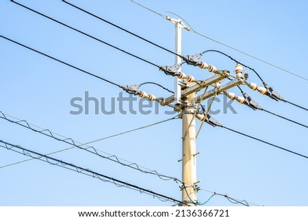 An electrical pole or utility pole under the blue sky, Energy or power image, Infrastructure Royalty-Free Stock Photo #2136366721