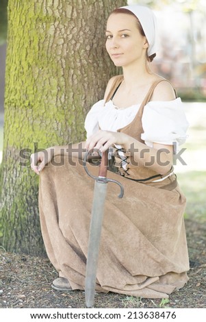 Woman in medieval dress with sword