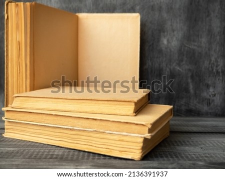 Stack of books on a wooden background. Education and training.
