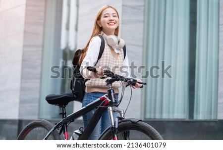 Young Asian woman using bicycle as a means of transportation
 Royalty-Free Stock Photo #2136401079