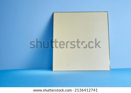blank beige color card against blue background