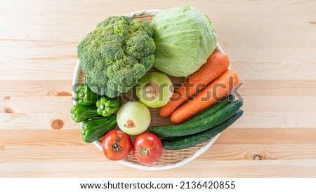 Assorted vegetables on a wood grain table.