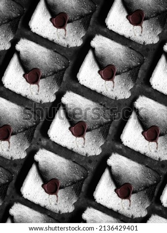 Creative pattern of vintage envelopes with red stamp made from bread. Creative black and white bread background