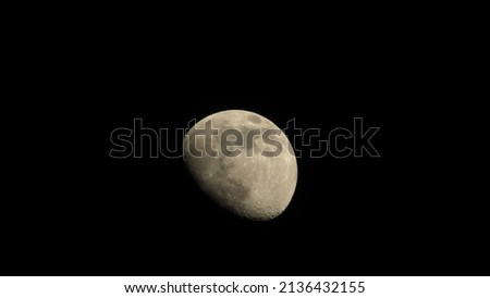 The moon in the night sky. Black lunar background. Wallpaper with the moon.