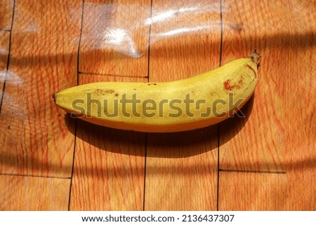 a banana on an orange background