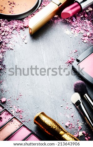 Frame with various makeup products in pink tone