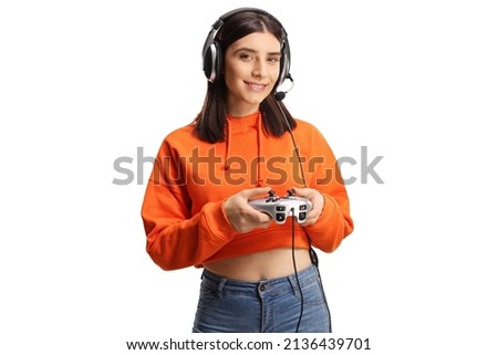 Cheerful young female with headphones and joystick isolated on white background