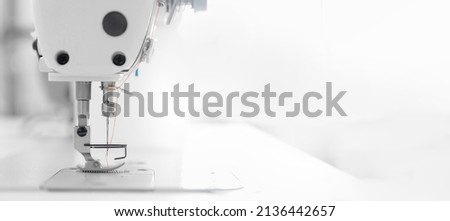 Banner industry tailor sewing machine on table workshop of white background.