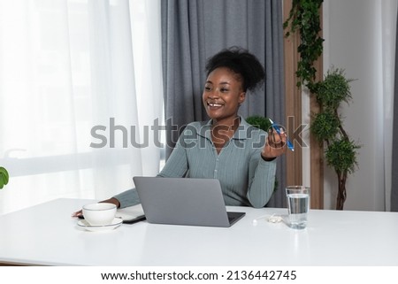 Young concentrated African American woman blogger and human rights activist writing a blog about cyber bullying and racism among young people through her personal negative experience. Royalty-Free Stock Photo #2136442745