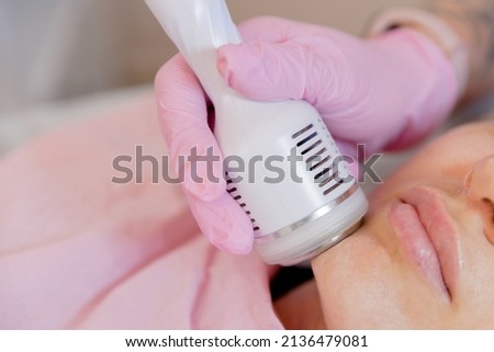 Hardware mesotherapy for the face. Dermapen apparatus photo. Cosmetology procedures. Cosmetic apparatus for lifting and mesotherapy. . Royalty-Free Stock Photo #2136479081