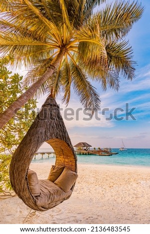 Tropical beach sunset as summer landscape with luxury resort beach palm swing hammock, sand seaside shore for sunset beach landscape. Tranquil beach horizon scenery vacation and summer holiday concept Royalty-Free Stock Photo #2136483545