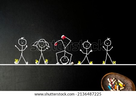 Inclusive education, concept. Children with special abilities, freehand stickman drawing on a blackboard and colored chalk Royalty-Free Stock Photo #2136487225