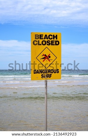 Yellow beach closed sign in Australia