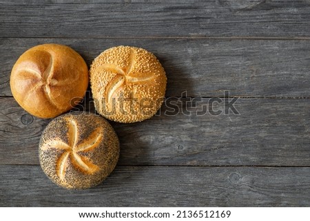 three light rolls with sesame and poppy seeds, copy space