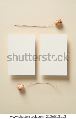Wedding invitations cards templates with dried flowers on beige background. Flat lay, top view, copy space.