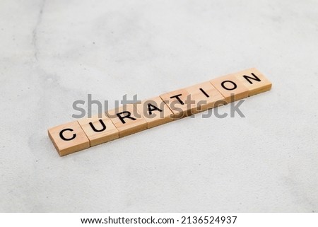 Top view of Curation word on wooden cube letter block on white background. Business concept