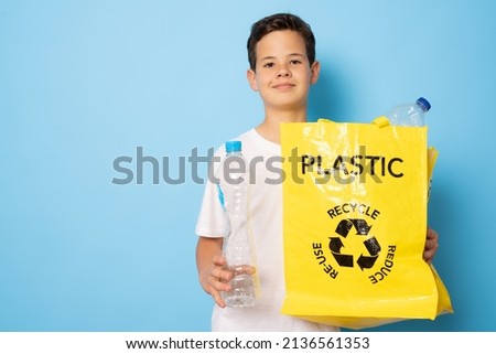 Child boy holding and sorting of plastic bottle in the box for Separation of waste bottle. Recycling concept.