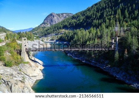 The Brilliant Suspension Bridge is a suspension bridge over the Kootenay River near Castlegar, British Columbia. The bridge was declared a national historic site in 1995.  Royalty-Free Stock Photo #2136566511
