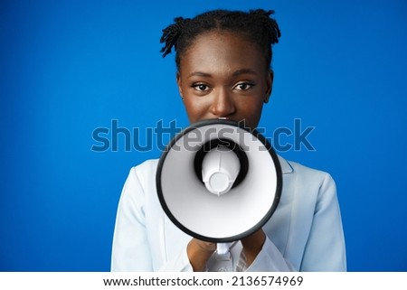 Afro american female doctor in white medical gown scream in megaphone in studio