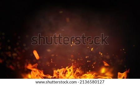Fire embers particles over black background. Fire sparks background. Abstract dark glitter fire particles lights.  Royalty-Free Stock Photo #2136580127