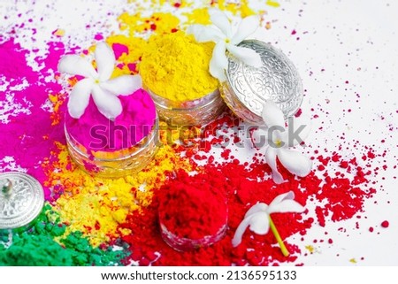 Indian festival Holi concept Multi color's silver bowl on white background