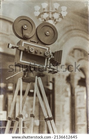 Vintage movie camera on a tripod, model. Processed with retro style. Cinema concept and other antiquities