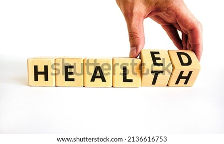Healed health symbol. Doctor turns wooden cubes and changes concept words Healed to Health. Beautiful white background. Medical healed health concept. Copy space. Royalty-Free Stock Photo #2136616753