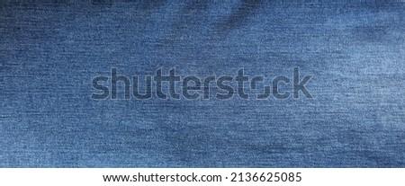 Close-up of blue denim jeans fabric texture background Royalty-Free Stock Photo #2136625085