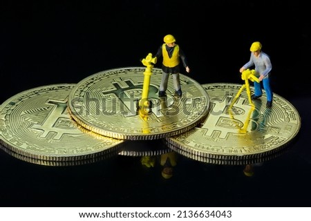 Concept of workers mining bit coin miniature people