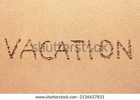 Vacation written on the sand 