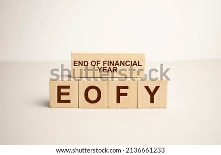 EOFY, End of Financial Year text. wood cubes and white background