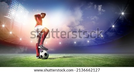 Football player and stadium with spotlights, 3d rendering Royalty-Free Stock Photo #2136662127