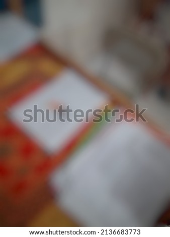 Defocused abstract background of teacher's table and its documents on it