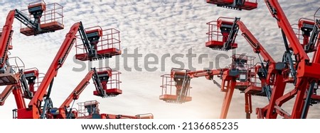 Articulated boom lift. Aerial platform lift. Telescopic boom lift against blue sky. Mobile construction crane for rent and sale. Maintenance and repair hydraulic boom lift service. Crane dealership. Royalty-Free Stock Photo #2136685235