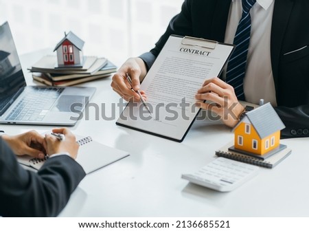 Real Estate Agent broker or House developer showing contract for buying house agreement to consultant employee.