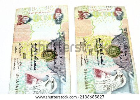 Obverse side of 500 AED five hundred Dirhams banknote of United Arab Emirates, currency of the UAE with a picture of Sparrowhawk at right, selective focus of Emirates money banknotes isolated on white