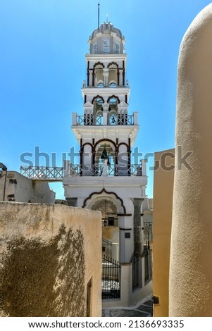 Orthodox Church with its multitiered bell tower facade in Emporio, Santorini, Greece.