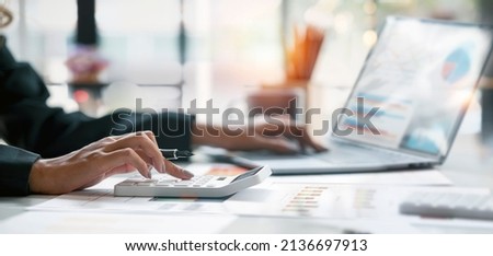 Businesswoman or accountant working Financial investment on calculator, calculate, analyze business and marketing growth on financial document data graph, Accounting, Economic, commercial concept. Royalty-Free Stock Photo #2136697913