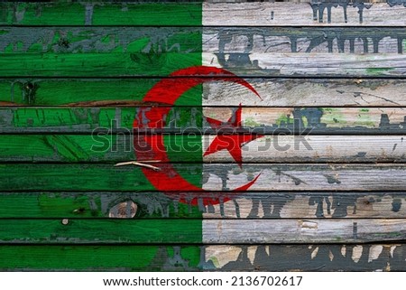The national flag of Algeria is painted on uneven boards. Country symbol.
