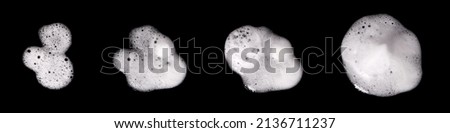 Top view, liquid white foam from soap or shampoo or shower gel. Abstract bubbles. isolated on a black background  Royalty-Free Stock Photo #2136711237