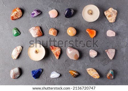 Mineral stones and candles on a black concrete background. The concept of using minerals in astrology and alternative or complementary medicine. Royalty-Free Stock Photo #2136720747