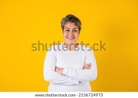hispanic matured woman portrait on yellow background in Mexico Latin America Royalty-Free Stock Photo #2136724973