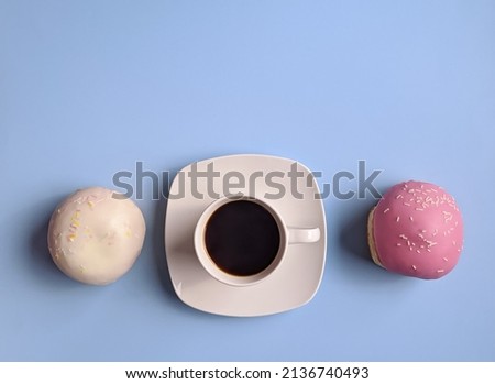 Morning with cup of hot coffee and sweet donuts on blue background. Top view, copy space, mockup. Flat lay. Food and drinks. Spring holidays. 