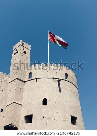 In this picture, the flag of the Sultanate of Oman is found in one of the ancient historical forts.