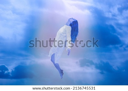 Ascension of the soul. The ghost of a woman ascends to heaven. Immortality, meditation, afterlife concept Royalty-Free Stock Photo #2136745531