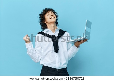 guy with laptop internet in a white shirt with a sweater cropped view