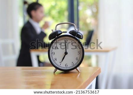 Alarm clock on the desk in the morning