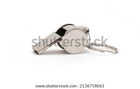 Close-up shot of a shiny metal whistle against a white background. Royalty-Free Stock Photo #2136758061