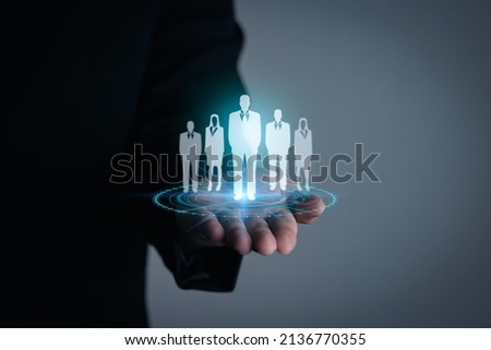 Personnel recruitment concept, job placement, strategic planning for personnel management and teamwork for success. businessman hand holding virtual businessman icon Royalty-Free Stock Photo #2136770355
